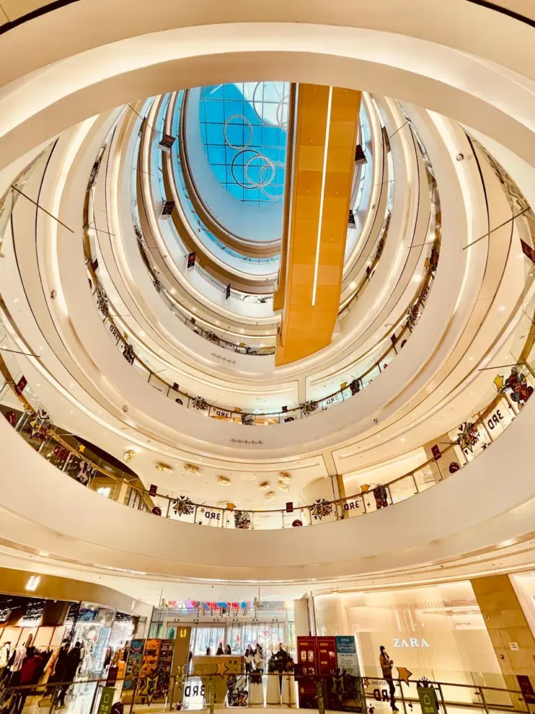 Stunning architectural design of a modern mall atrium with a circular skylight.