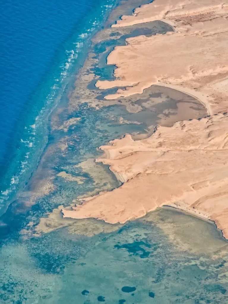 Stunning aerial view of the Red Sea coastline near Hurghada, Egypt showcasing sandy shores and vibrant waters.
