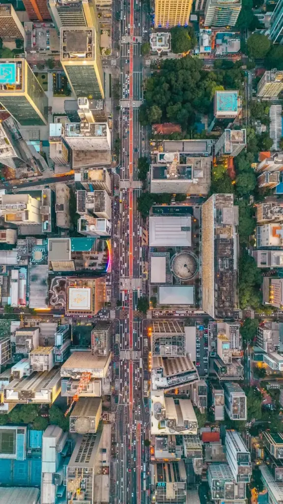 Vibrant aerial cityscape showcasing crowded streets and towering skyscrapers from above.