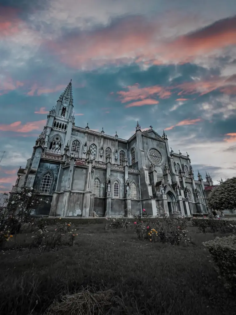 Stunning Gothic Revival church in Costa Rica captured at dusk against a dramatic sky.
