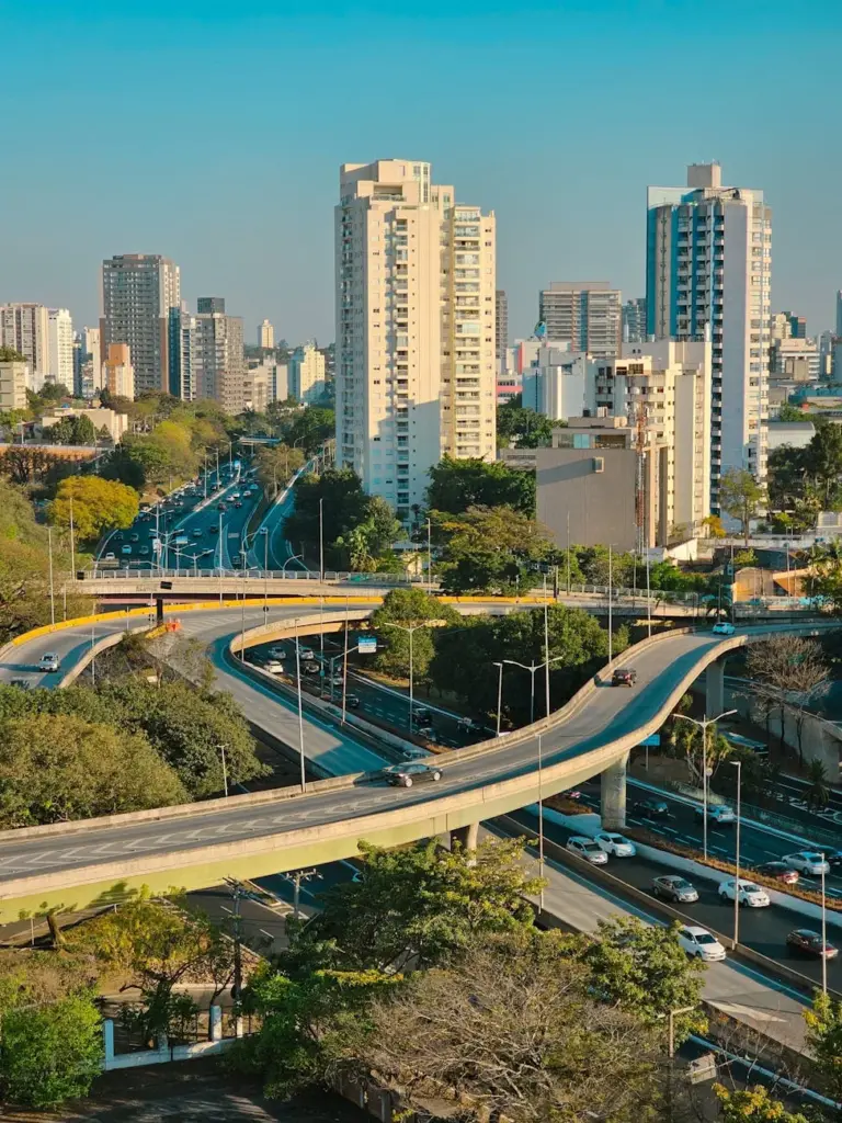 A stunning aerial view showcasing a modern urban cityscape with winding overpasses and tall buildings.