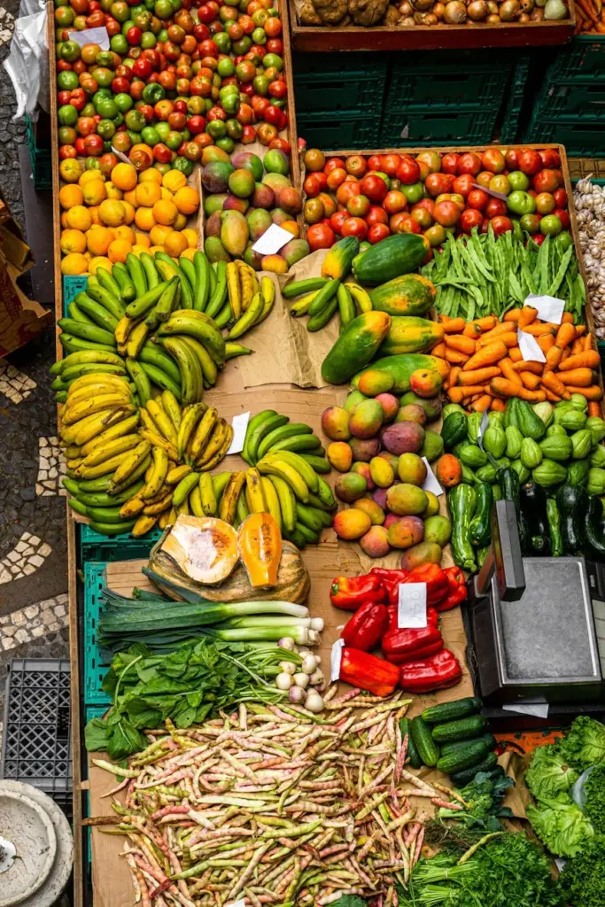 Colorful display of fresh fruits and vegetables at a market in Madeira, Portugal.