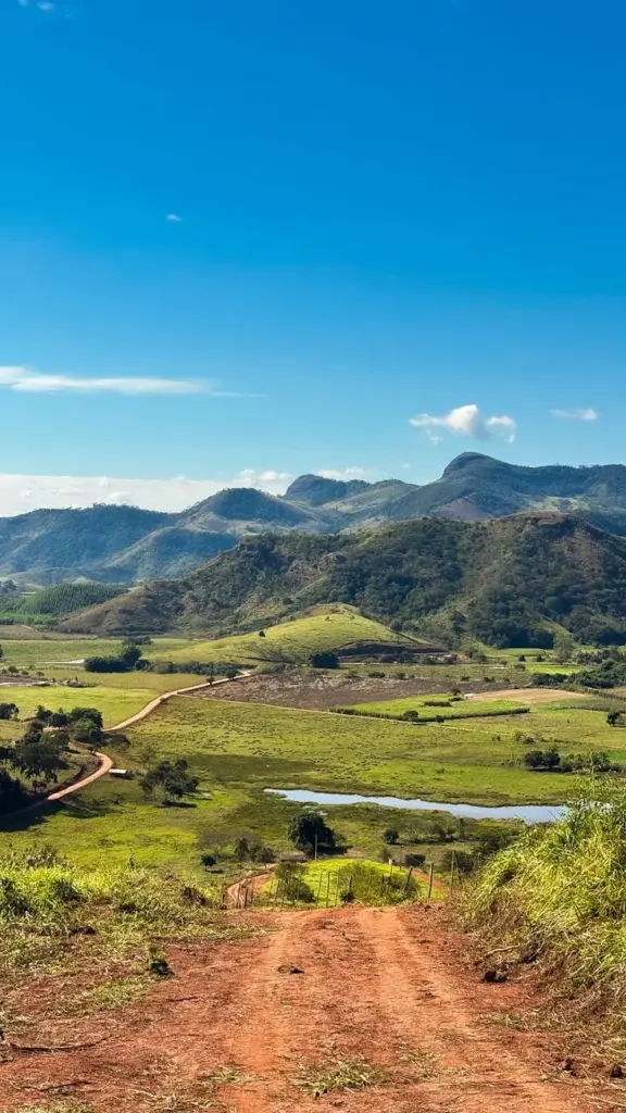 Breathtaking view of a countryside landscape with mountains under a clear blue sky.