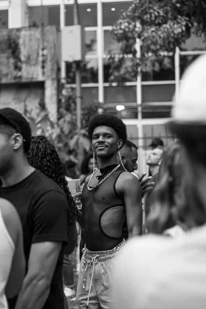 Stylish person smiling at outdoor gathering in monochrome.