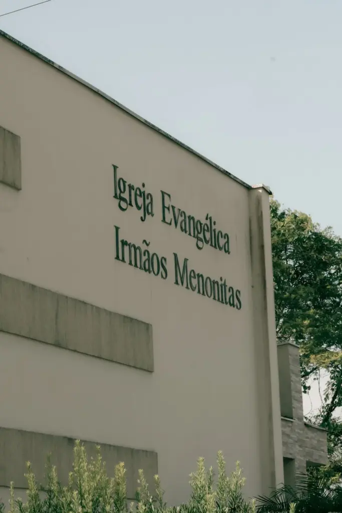 Exterior view of Igreja Evangélica Irmãos Menonitas with visible signage on a sunny day.