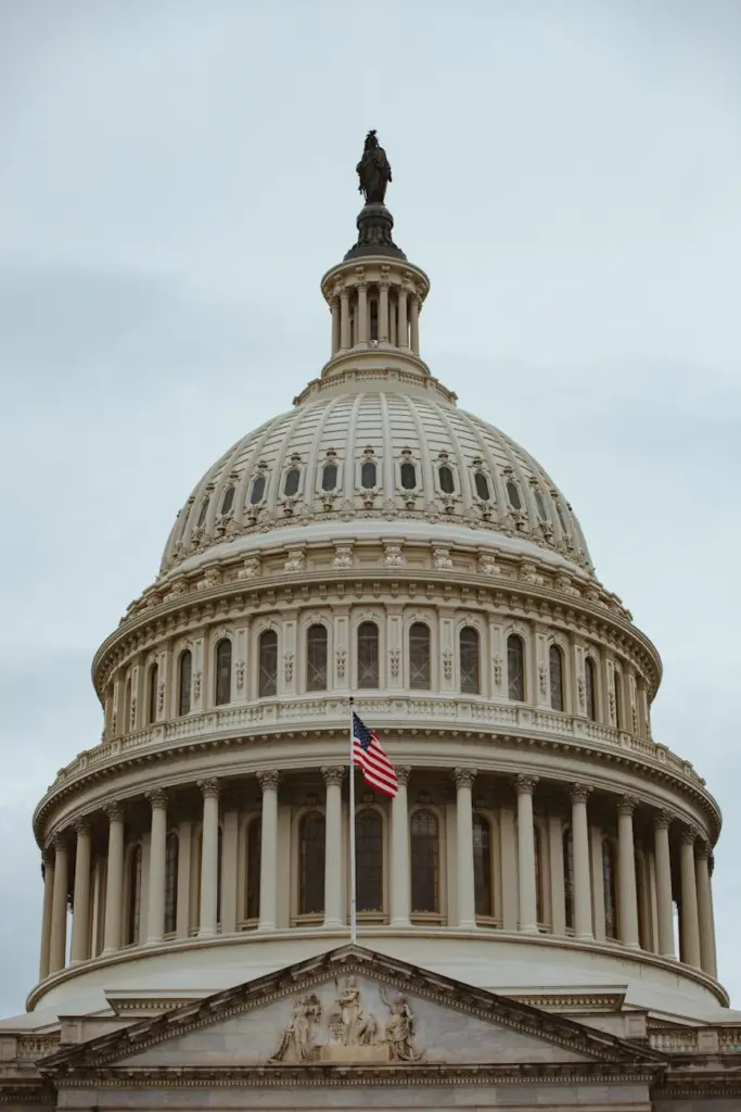 A captivating shot of the iconic US Capitol building dome in Washington, D.C. with the American flag.