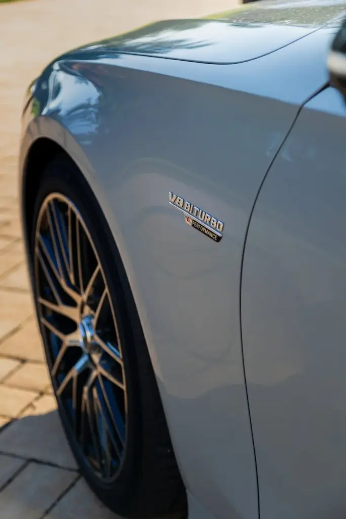 Close-up of Mercedes Benz S-Class showing V8 Biturbo badge and sleek design.