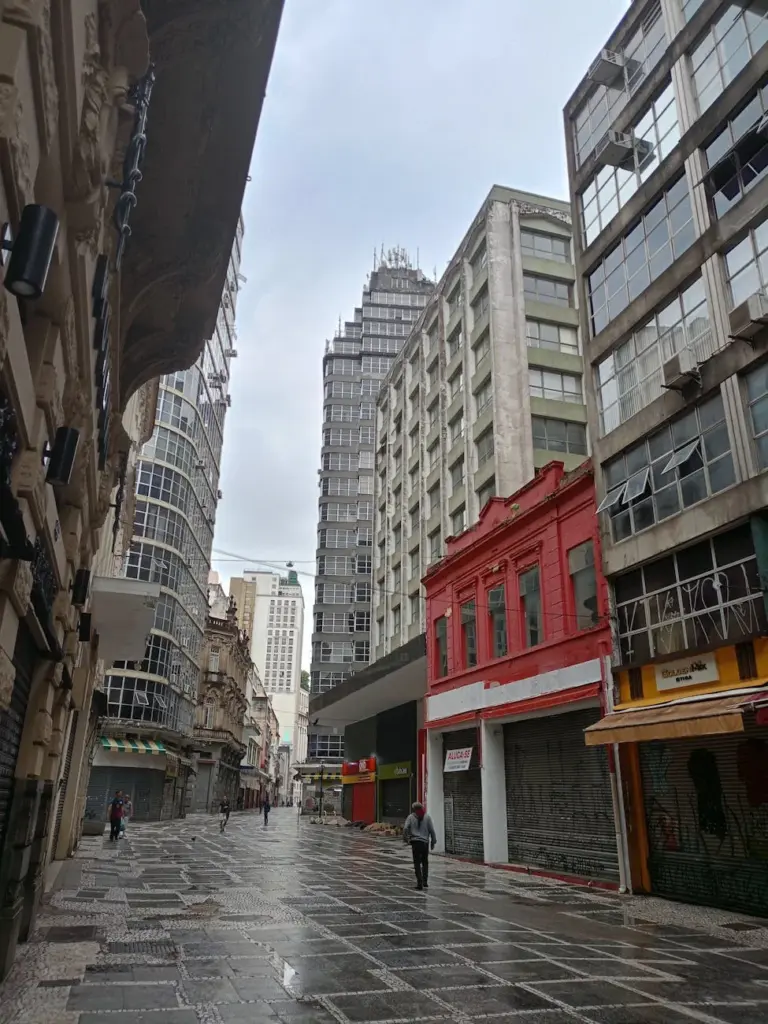 A vibrant cityscape of downtown São Paulo, showcasing modern architecture and empty streets.