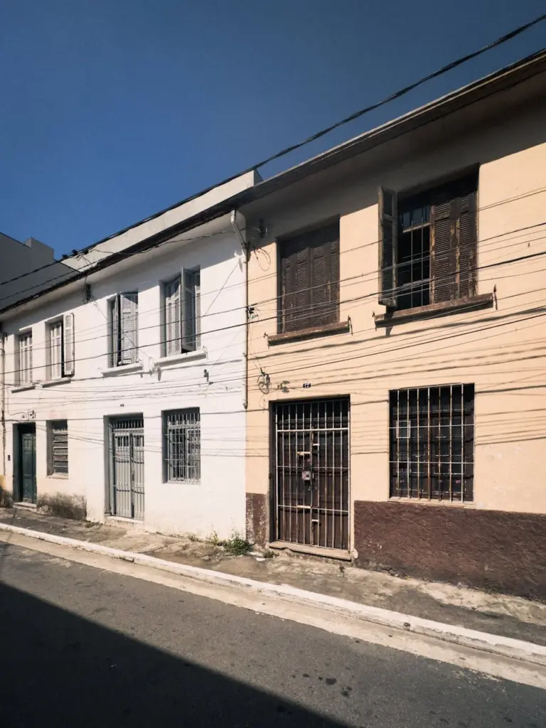 Historic residential buildings on a sunny urban street.