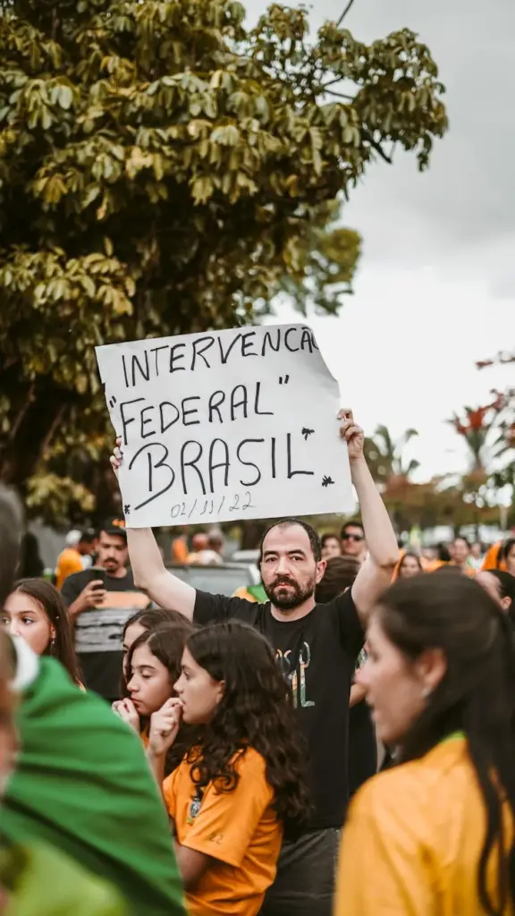 A crowd participates in a peaceful protest in Brazil, featuring a prominent sign.