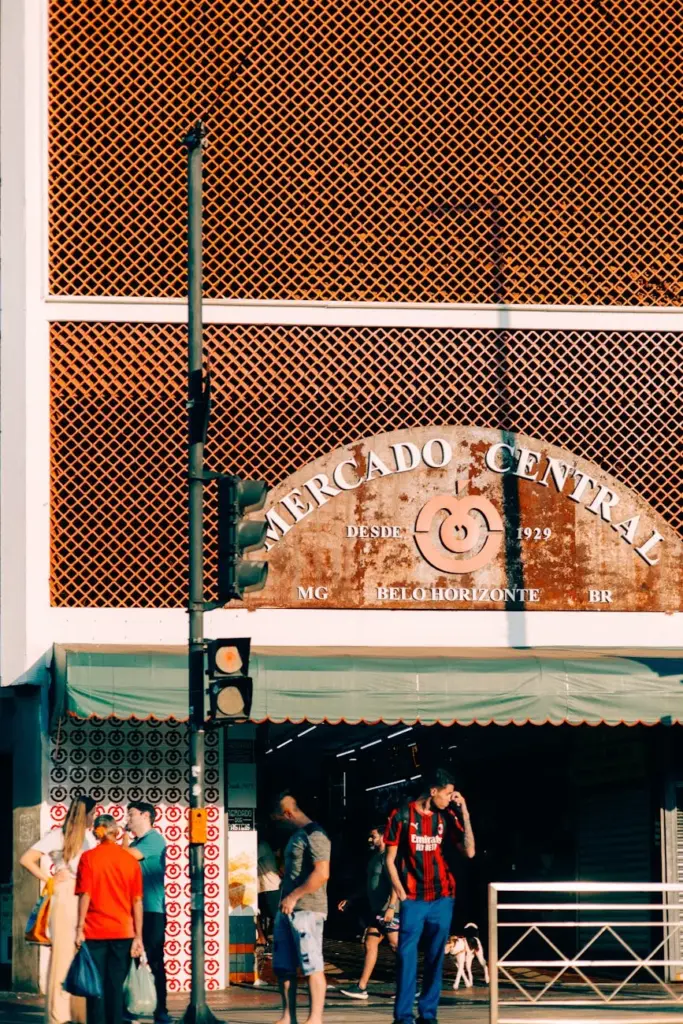Exterior view of Mercado Central, Belo Horizonte, featuring people and vibrant storefront.