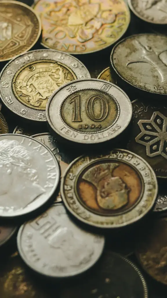 Closeup of heap of old golden and silver coins placed next to each other