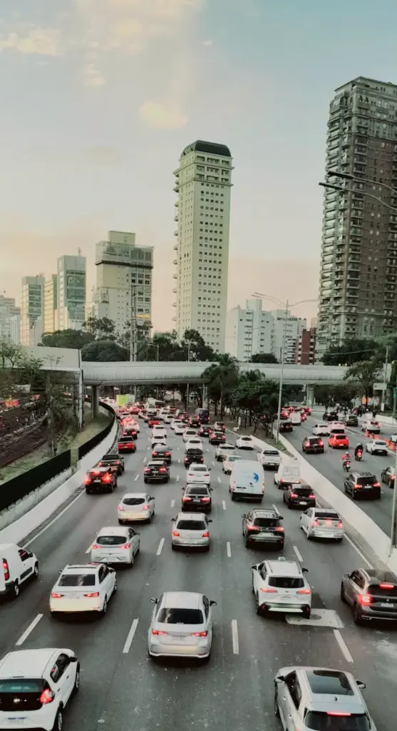 Heavy traffic crosses an expressway amidst modern skyscrapers in São Paulo, Brazil.