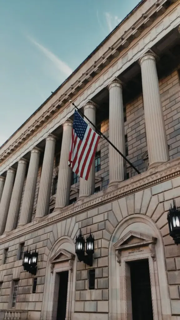 A majestic neoclassical building with the US flag, showcasing Washington DC's architectural heritage.