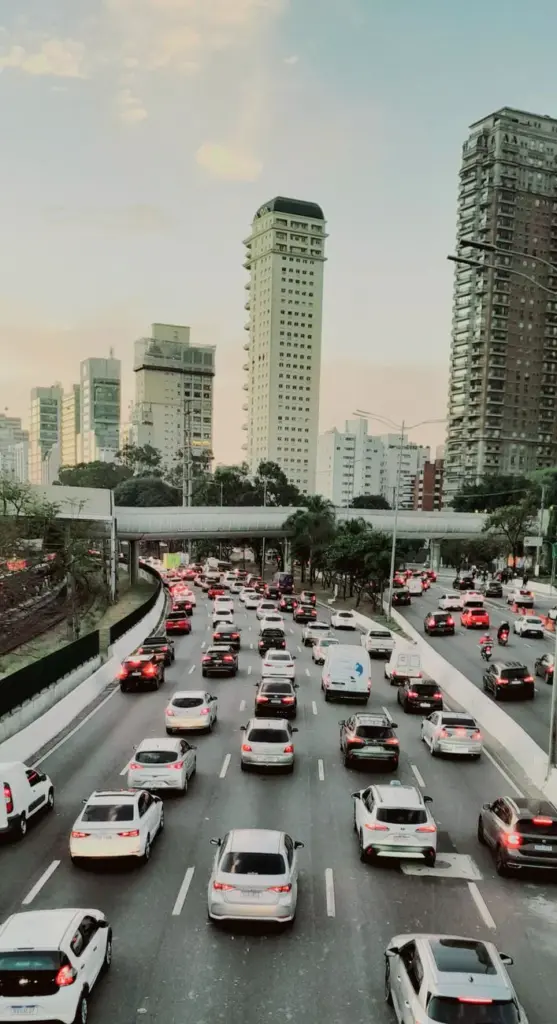 Heavy traffic crosses an expressway amidst modern skyscrapers in São Paulo, Brazil.