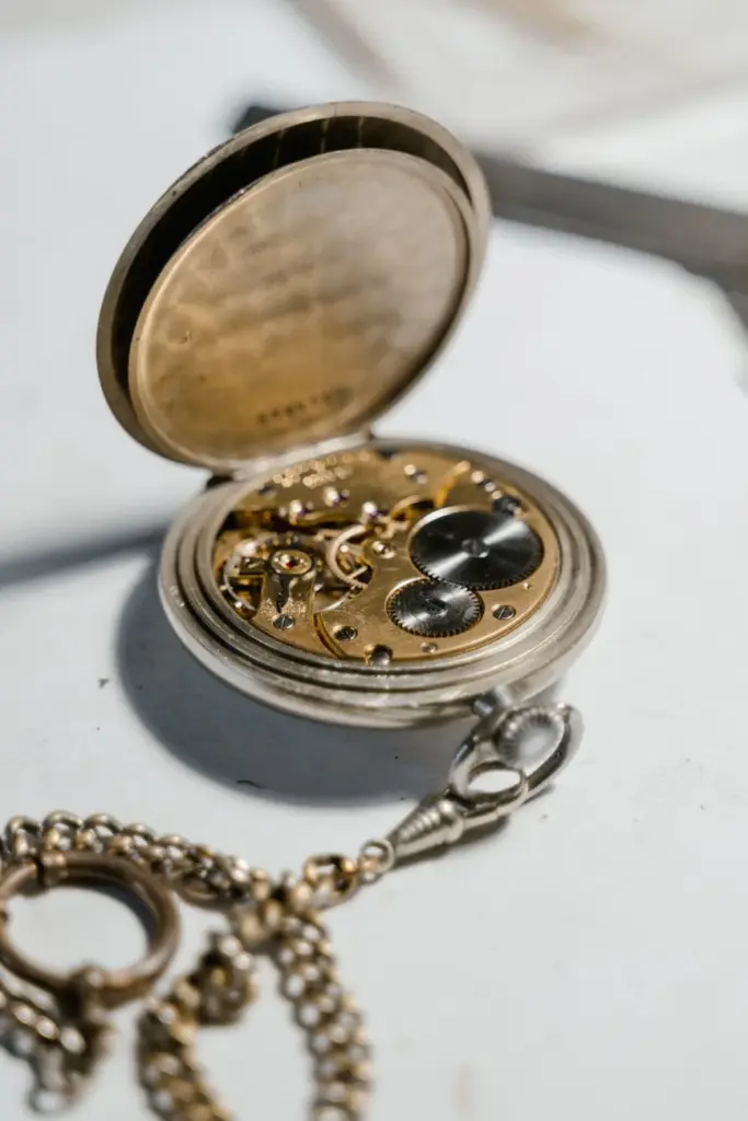 Close-up of an antique pocket watch showing its intricate mechanism details.
