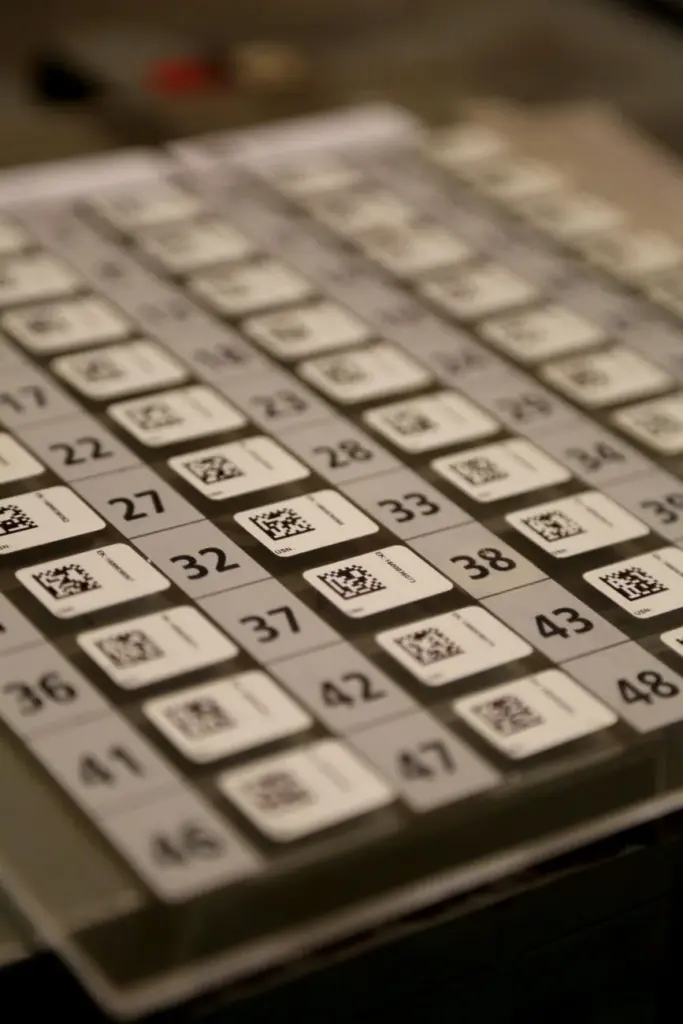 Detailed view of a multiplication table with QR codes on a calculator, showcasing numbers and technology.