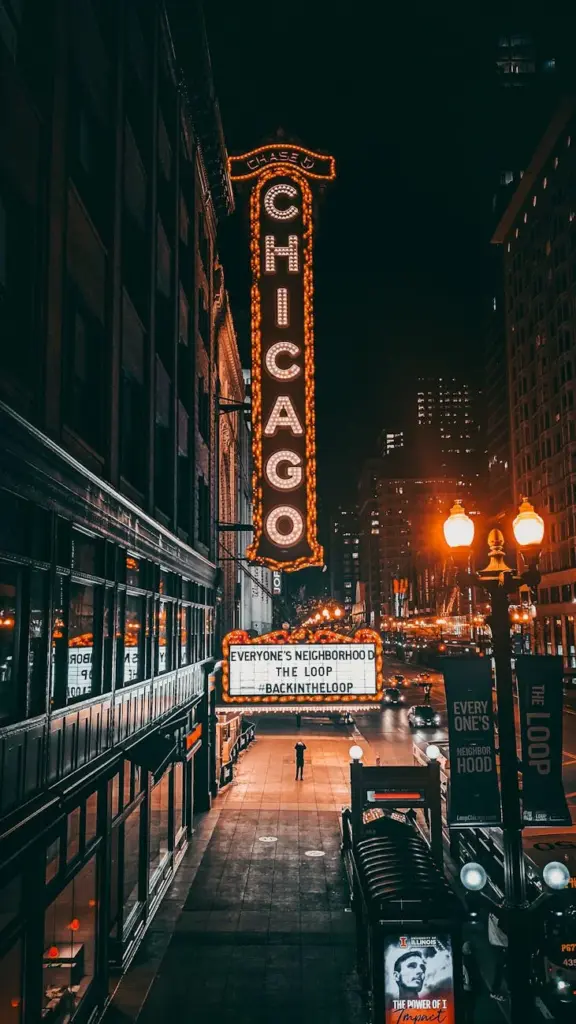 A vibrant capture of Chicago Theater with illuminated signage in downtown at night.