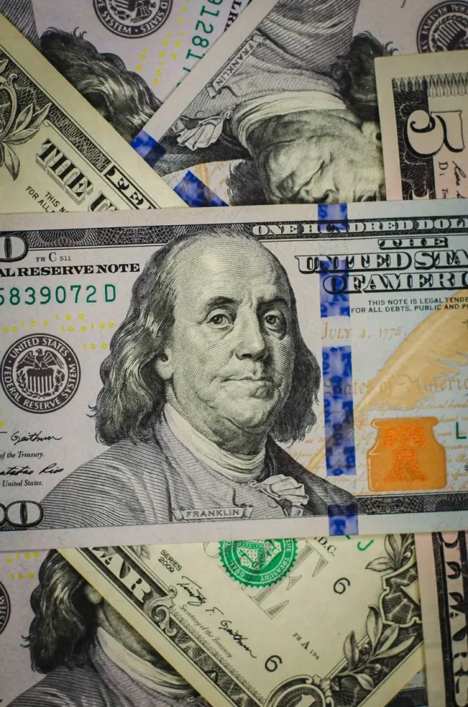 A detailed photograph of diverse US dollar bills including different denominations.