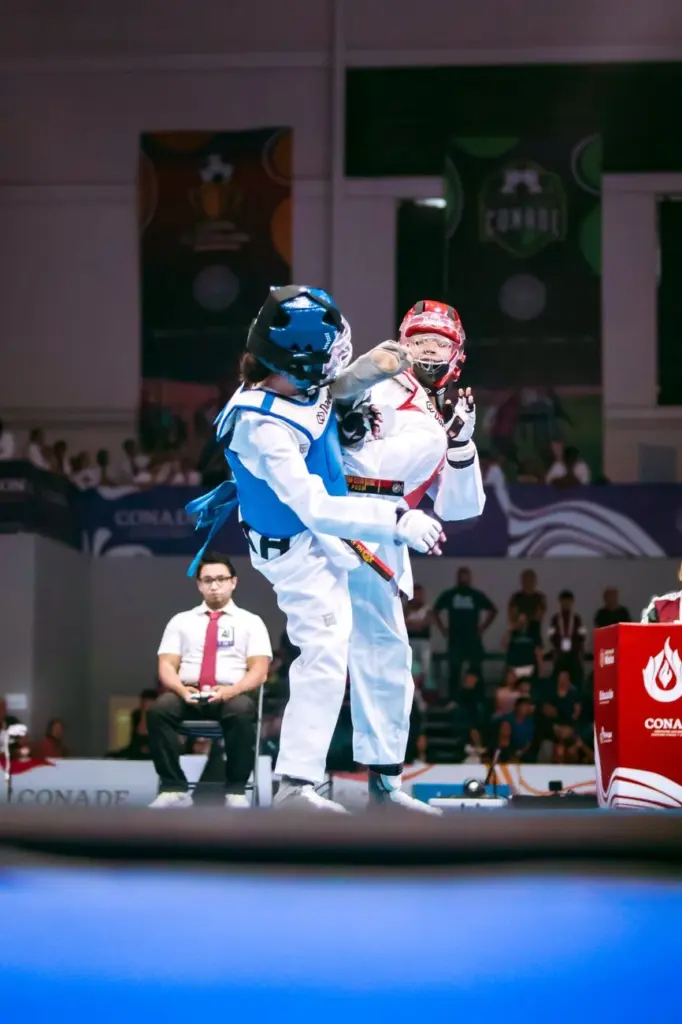 Two athletes in a thrilling taekwondo match at a live event in Tlaxcala, Mexico.
