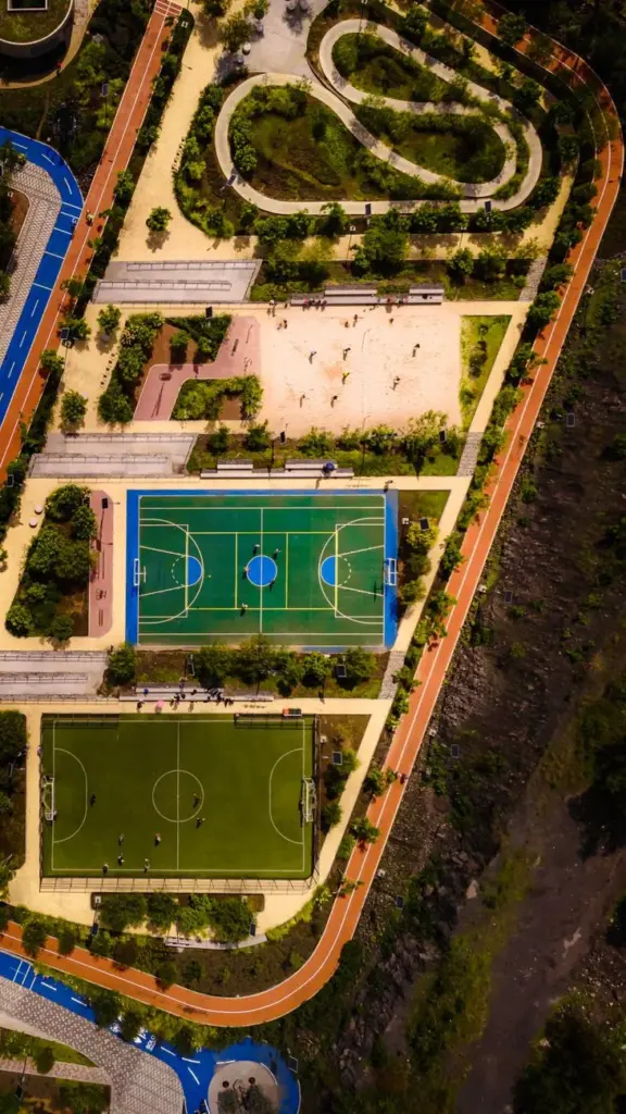 Drone shot of sports complex with basketball and soccer fields in Mexico City.