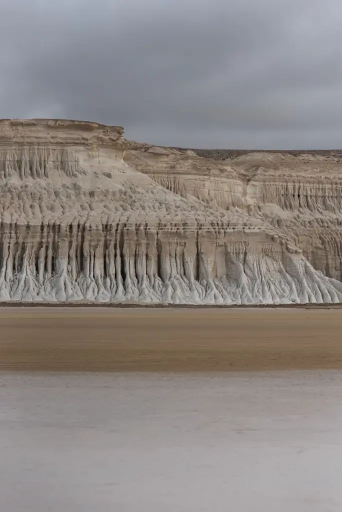 Explore the striking cliff formations in Mangystau, Kazakhstan, under a cloudy sky.