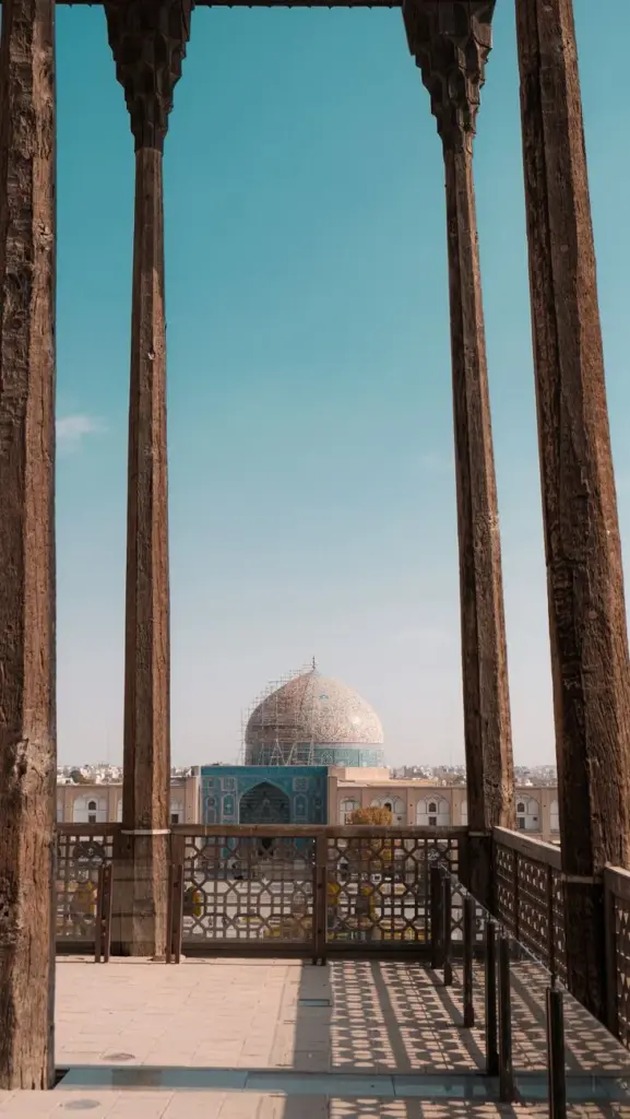Captivating view of Sheikh Lotfollah Mosque through historical arches in Isfahan, Iran.