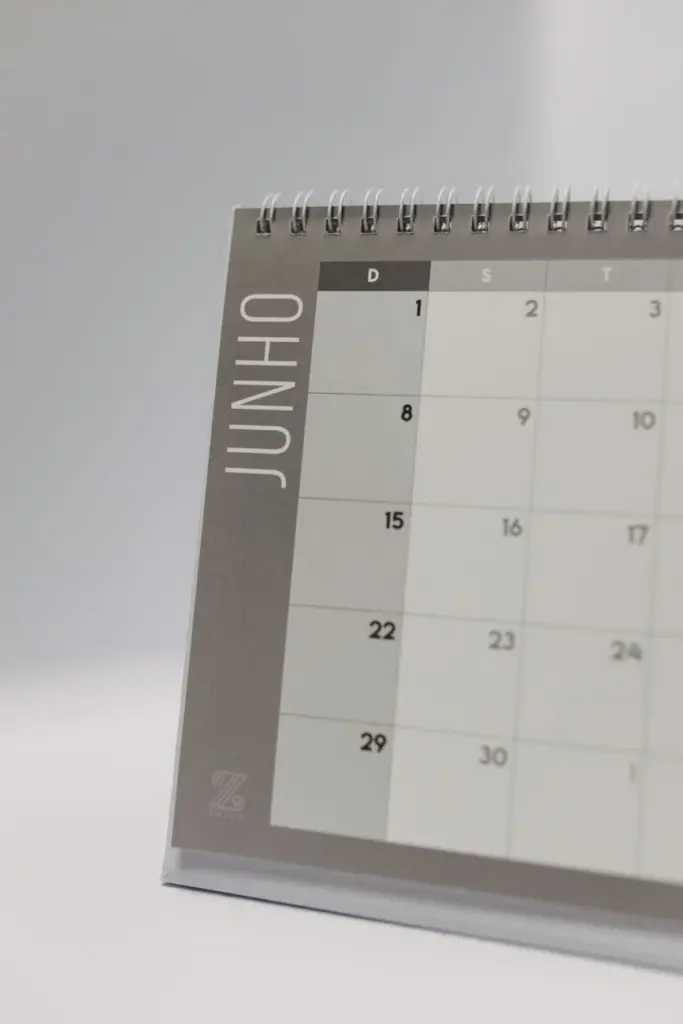 Spiral-bound desk calendar open to June in minimalist style.