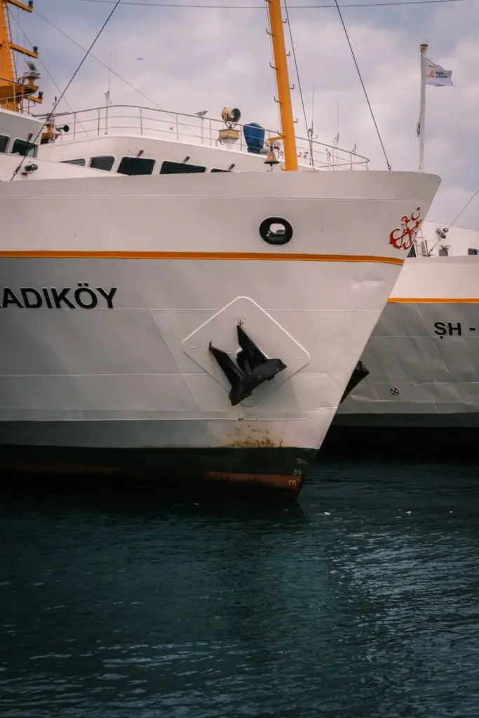 A detailed view of a ship with the name Kadıköy docked at a port, showcasing maritime details.
