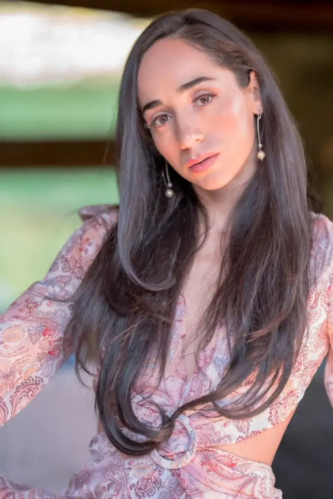Elegant portrait of a woman in a pink bohemian dress, showcasing fashion and style.
