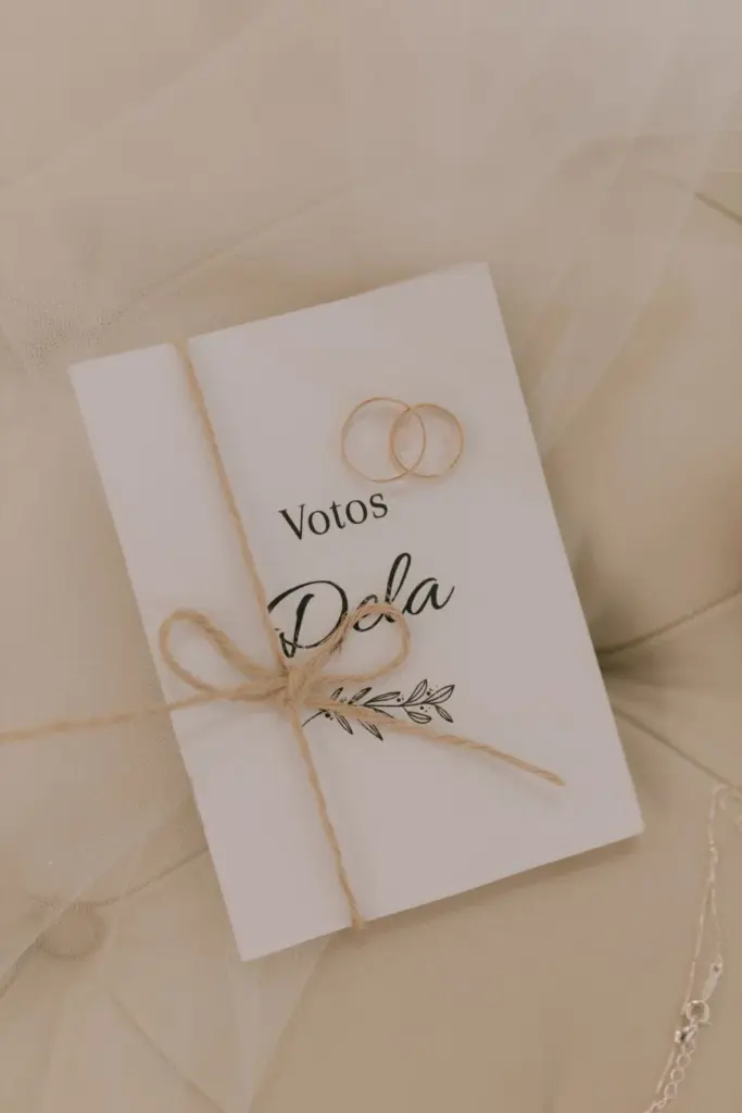 Close-up of a wedding vows booklet with elegant design and rings, perfect for ceremonies.