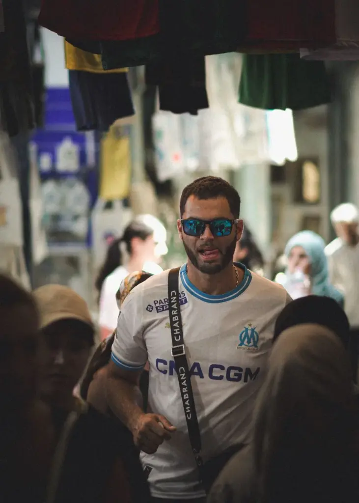 Man in stylish streetwear in Tunis medina markets, vibrant cultural vibe